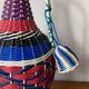Old glass bottle and vintage scoubidou plastic weaving
