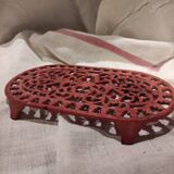 Vintage oval dark coral pink cast iron trivet