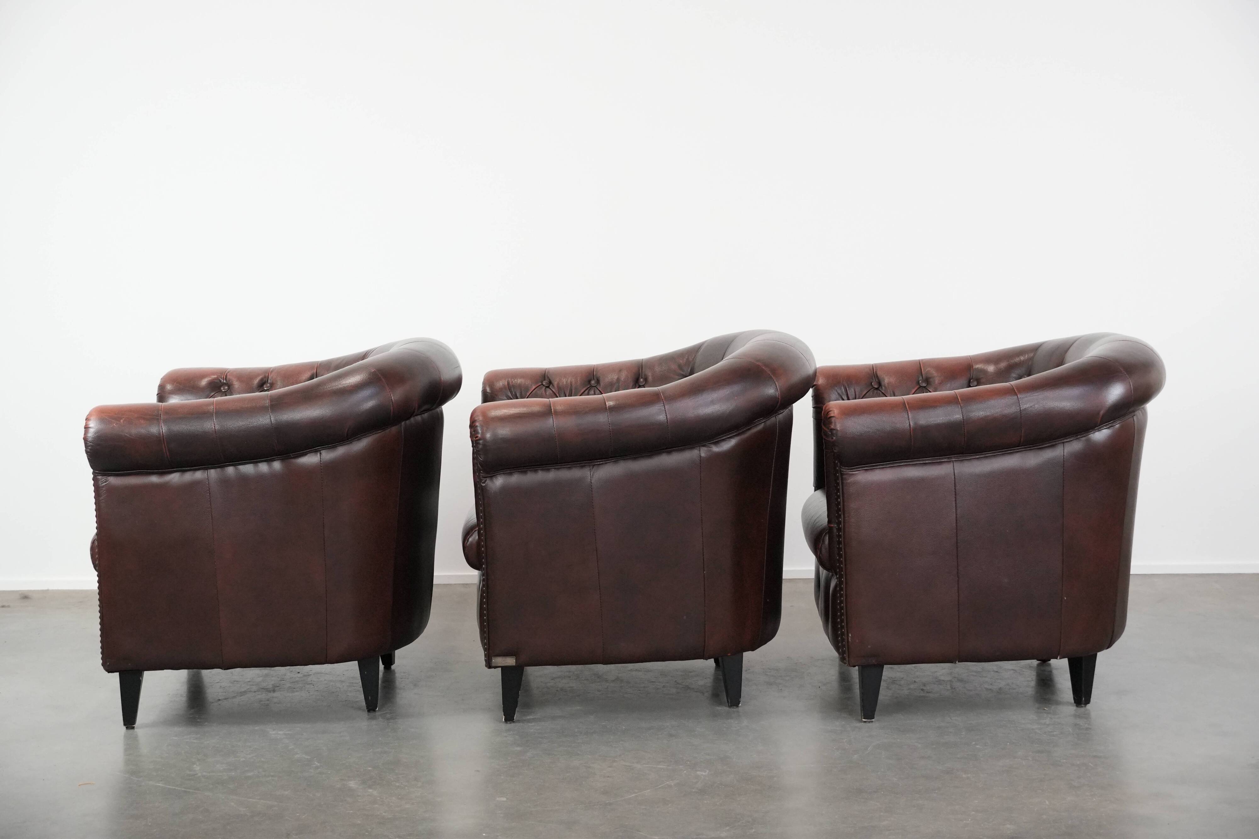 Set of three classic English-style Chesterfield cowhide  club armchairs