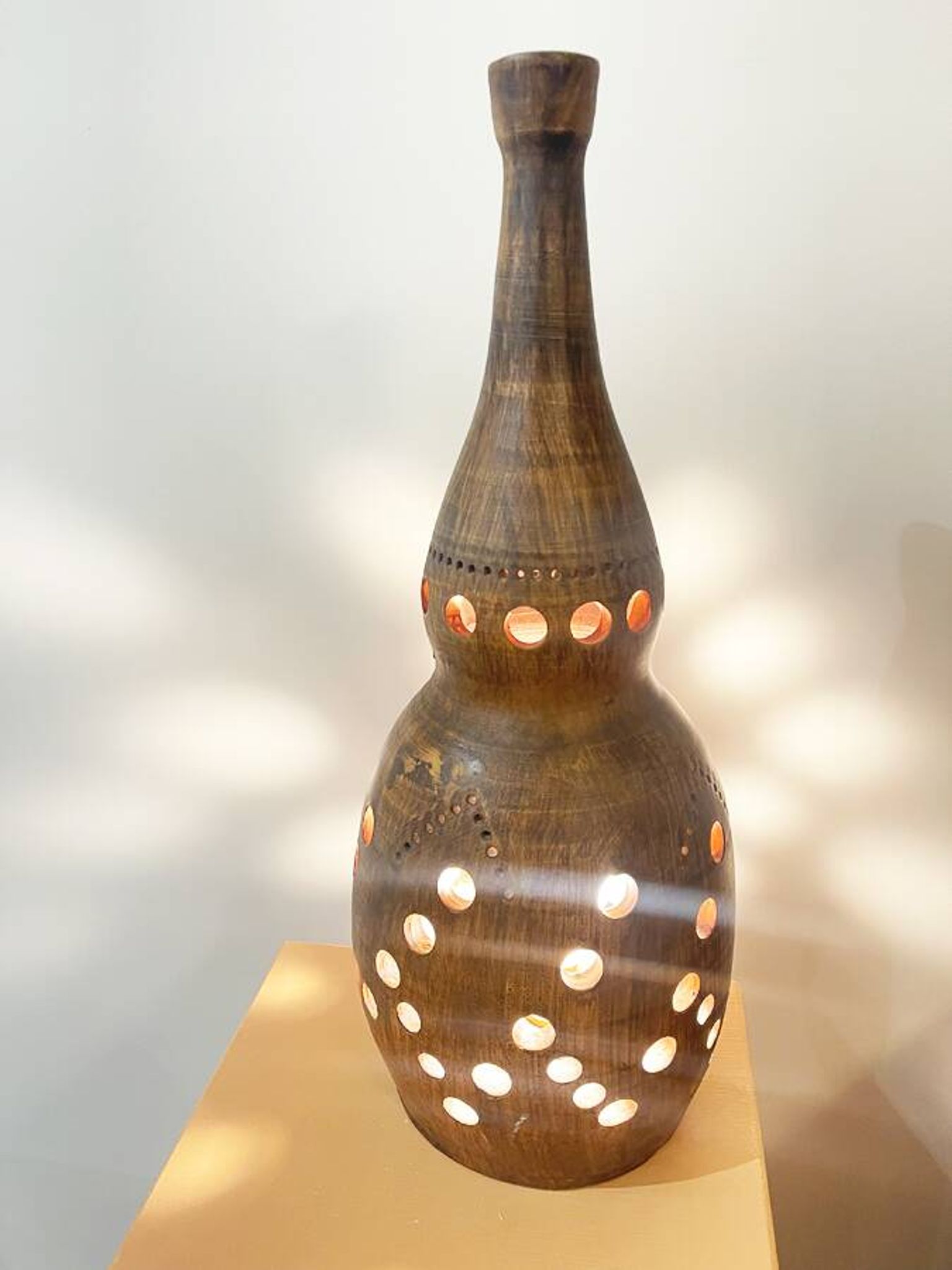 Terracotta lamp with cut-outs, circa 1970.
