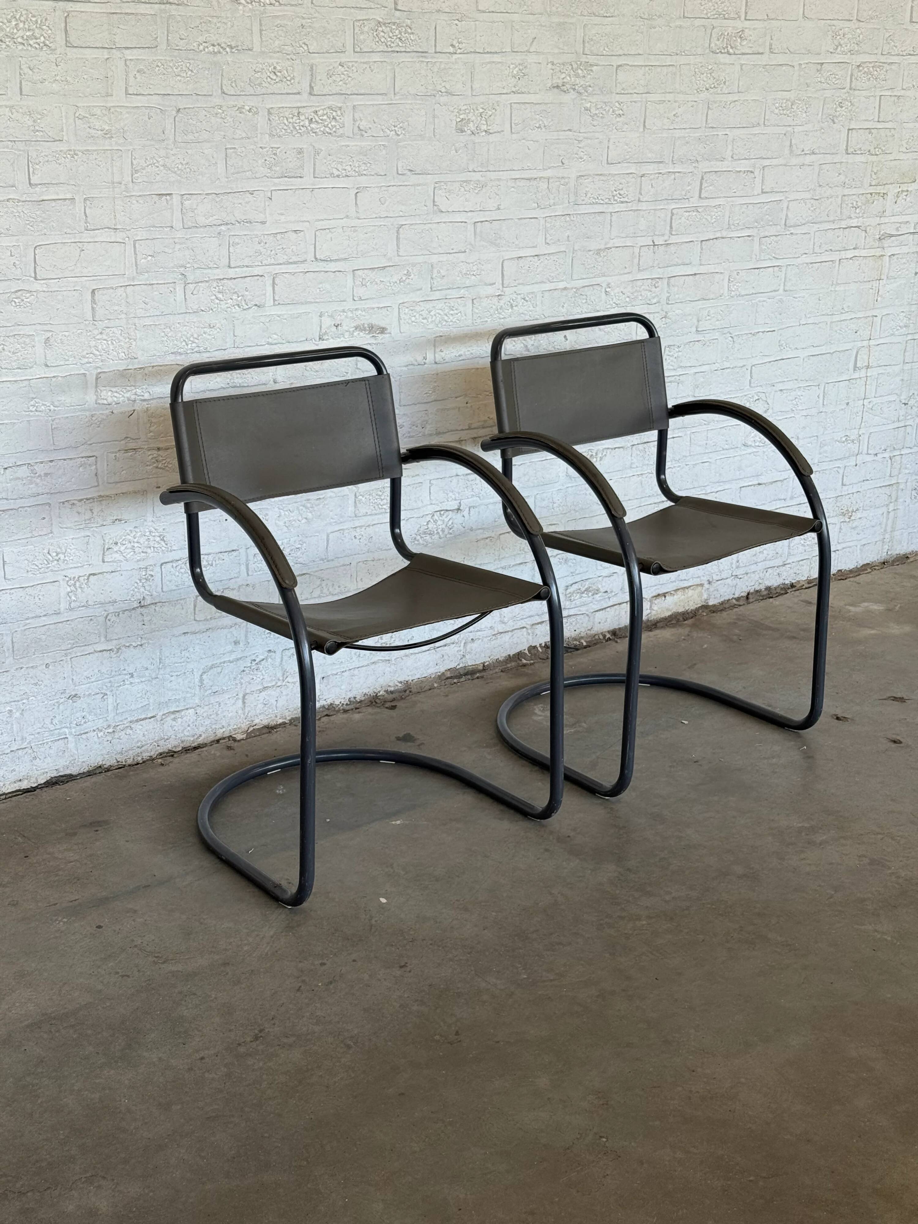 Vintage cantilever lounge chairs — pair, grey leather and tubular steel