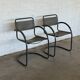Vintage cantilever lounge chairs — pair, grey leather and tubular steel