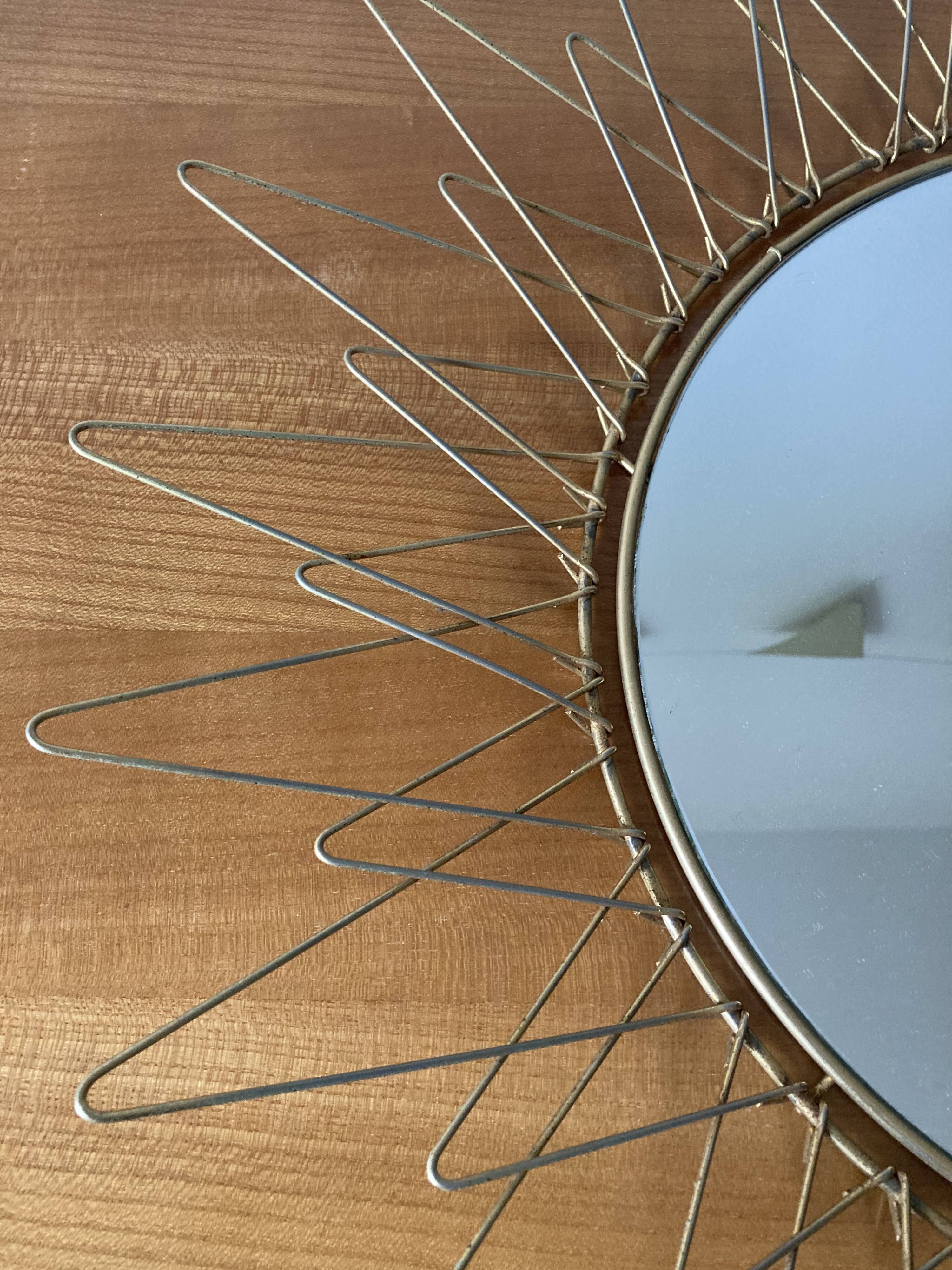 Sun mirror in gilded metal