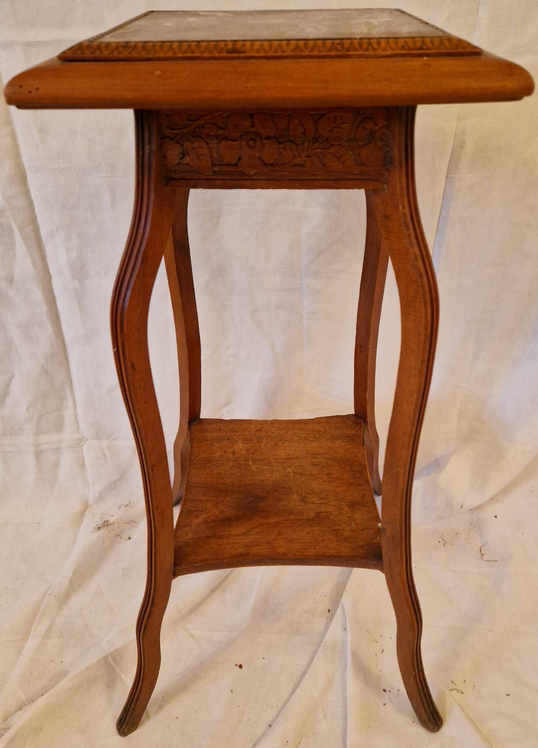 Antique Art Nouveau pedestal table with carved wood and marble top.
