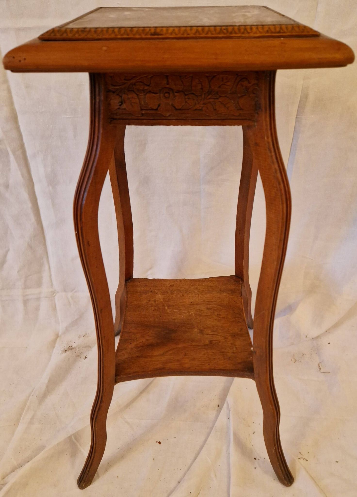 Antique Art Nouveau pedestal table with carved wood and marble top.