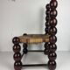 Brutalist wood turned bobbin low rush chair n the style of Charles Dudouyt