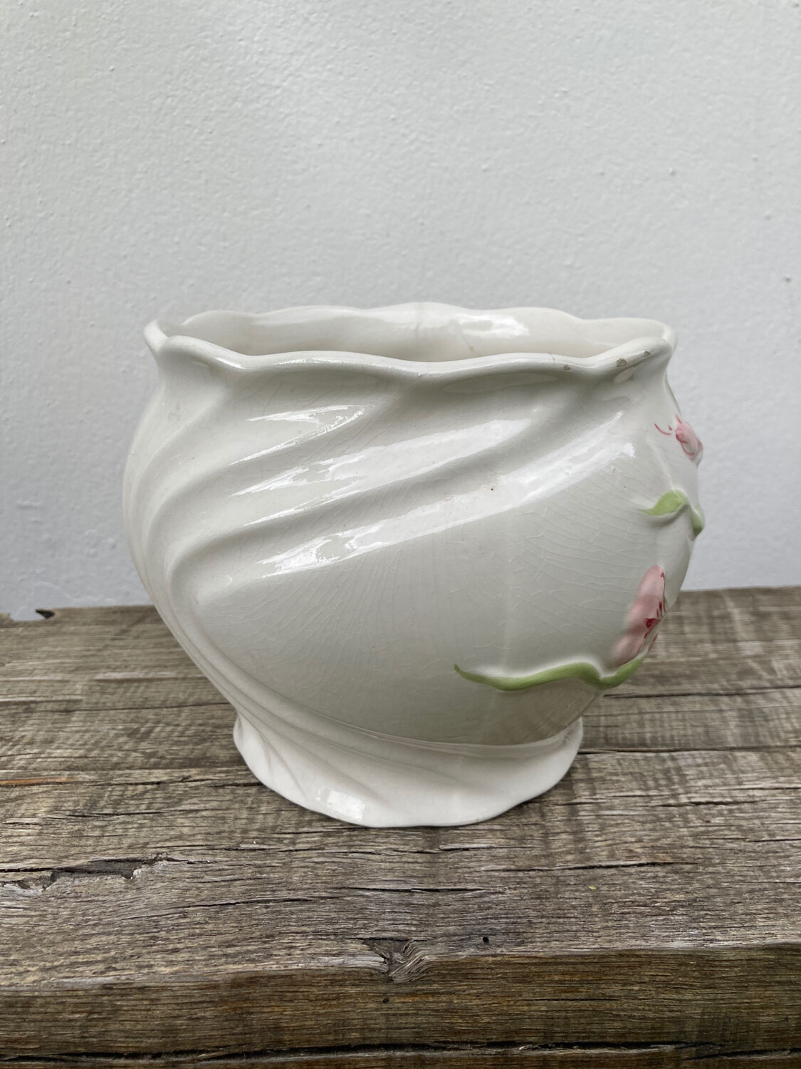 White ceramic pot cache in old flower slip