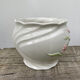 White ceramic pot cache in old flower slip