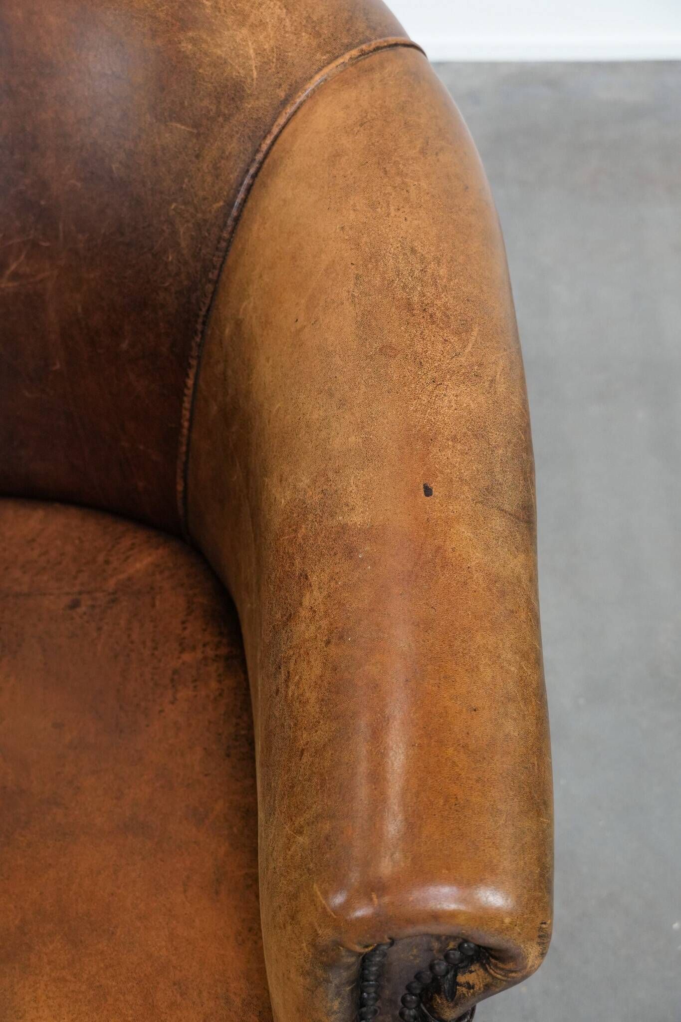 Vintage club chair in sheepskin leather with a characterful look