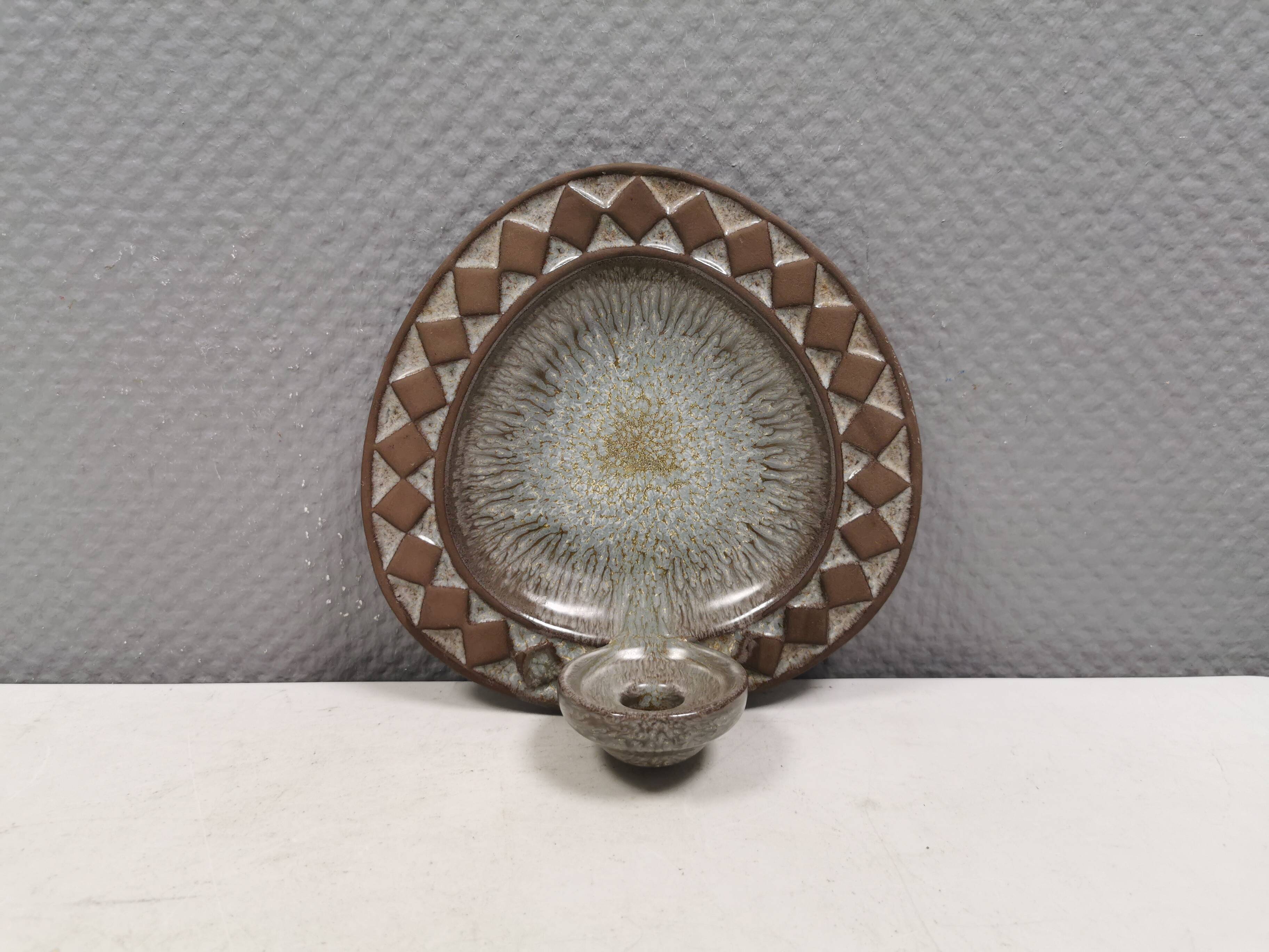 Wall-mounted candlestick in grayish colors, Danish and from the 1970s-80s.