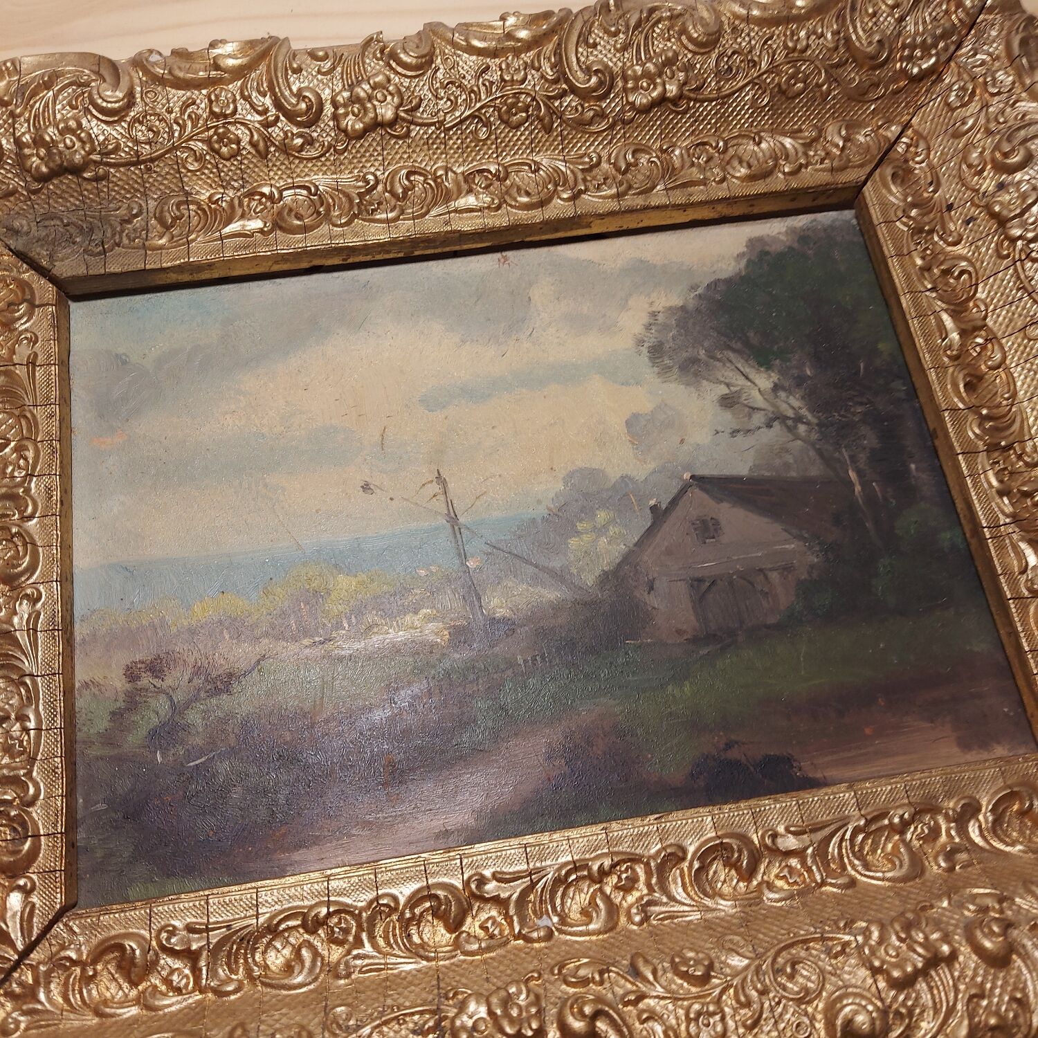 Oil on framed panel depicting a country house