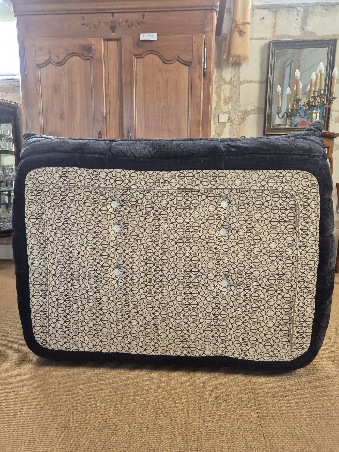 Togo sofa by Ligne Roset and its pouf from the 1970s.