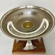Art deco cut rosewood sphere enclosed in silver metal foot