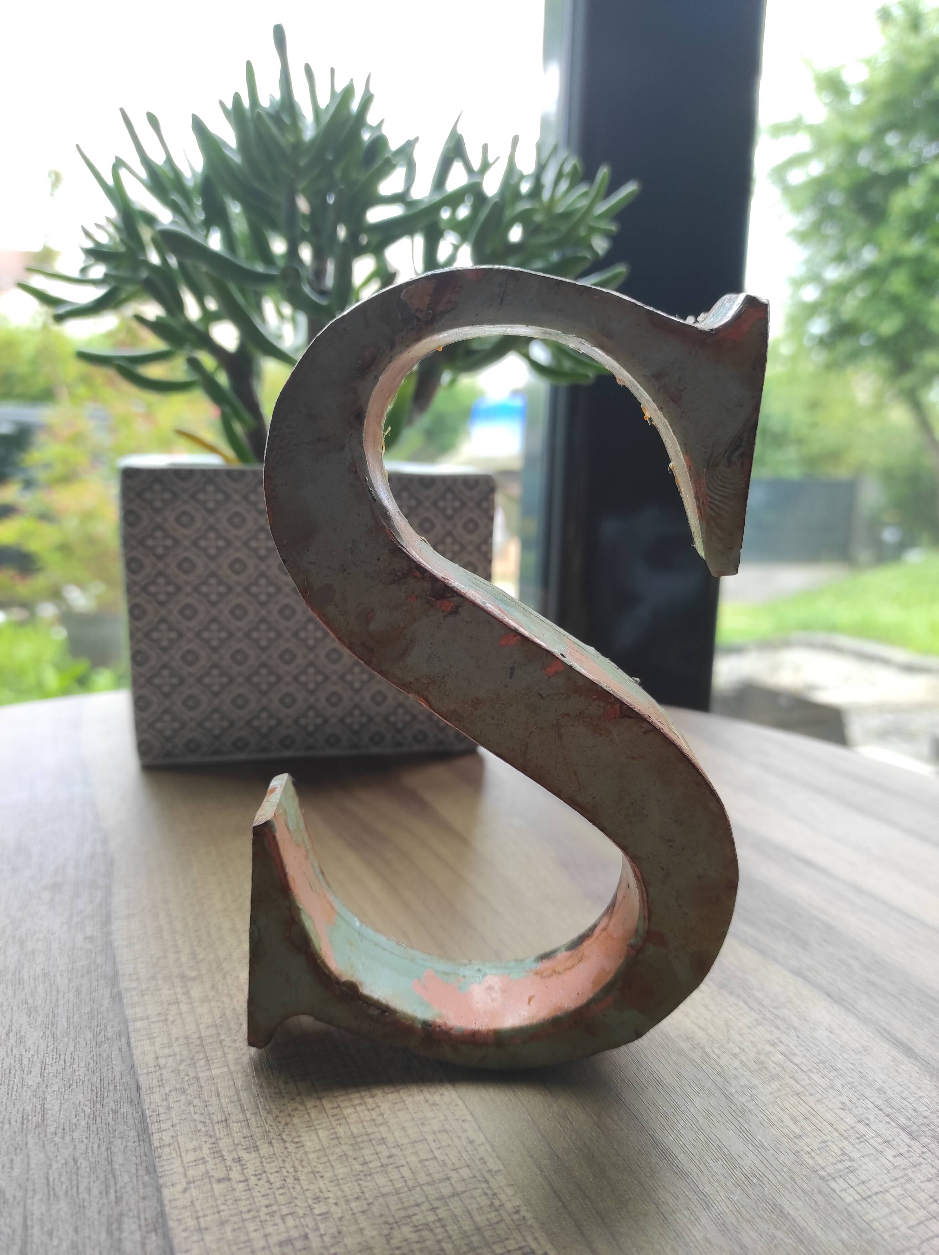 Old sign letter "S" in patinated metal