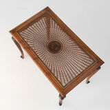 Side table with sculpted elements and rattan top
