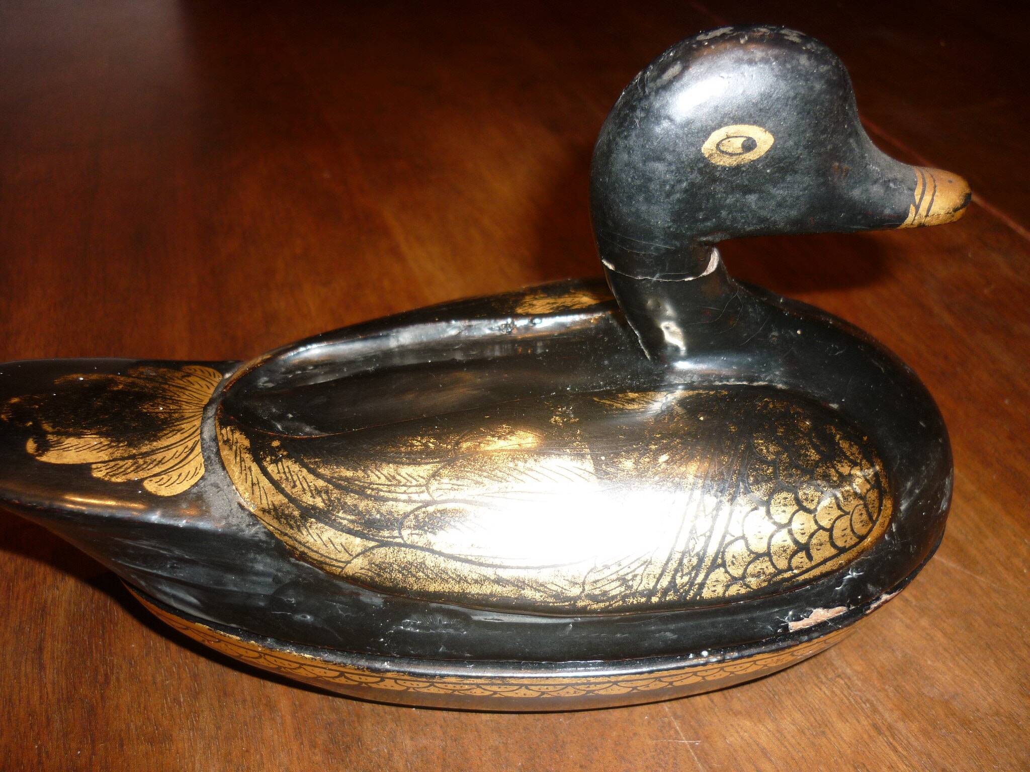 Black and gold wooden duck