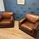 Ensemble de deux fauteuils en cuir de buffle.