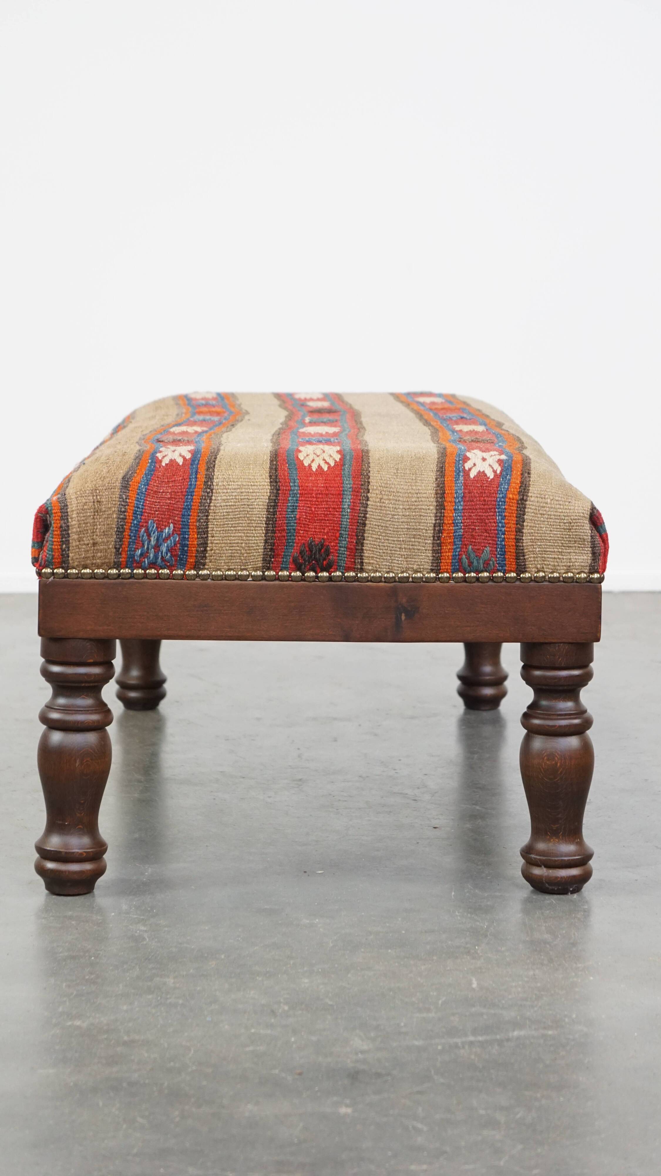 Oriental pouf upholstered in an antique kilim
