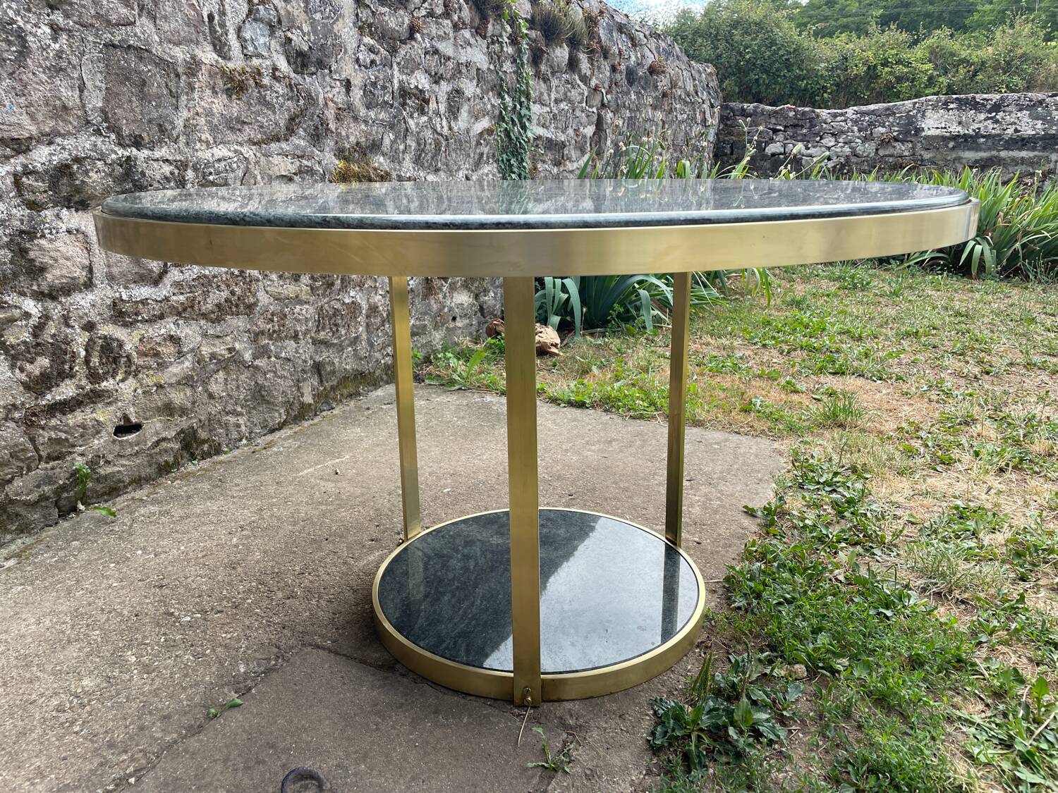 Round dining table with green marble and solid brass.