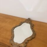 Bakelite scrolled mirror with rocaille pediment