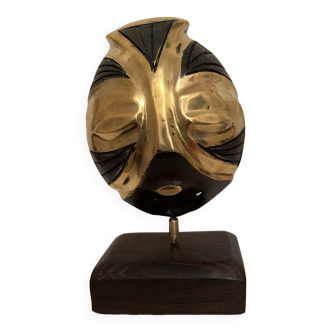 African decorative metal mask with gold and black finishes