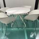 4 Tom Vac chairs designed by Ron Arad with a white round table of 110cm.