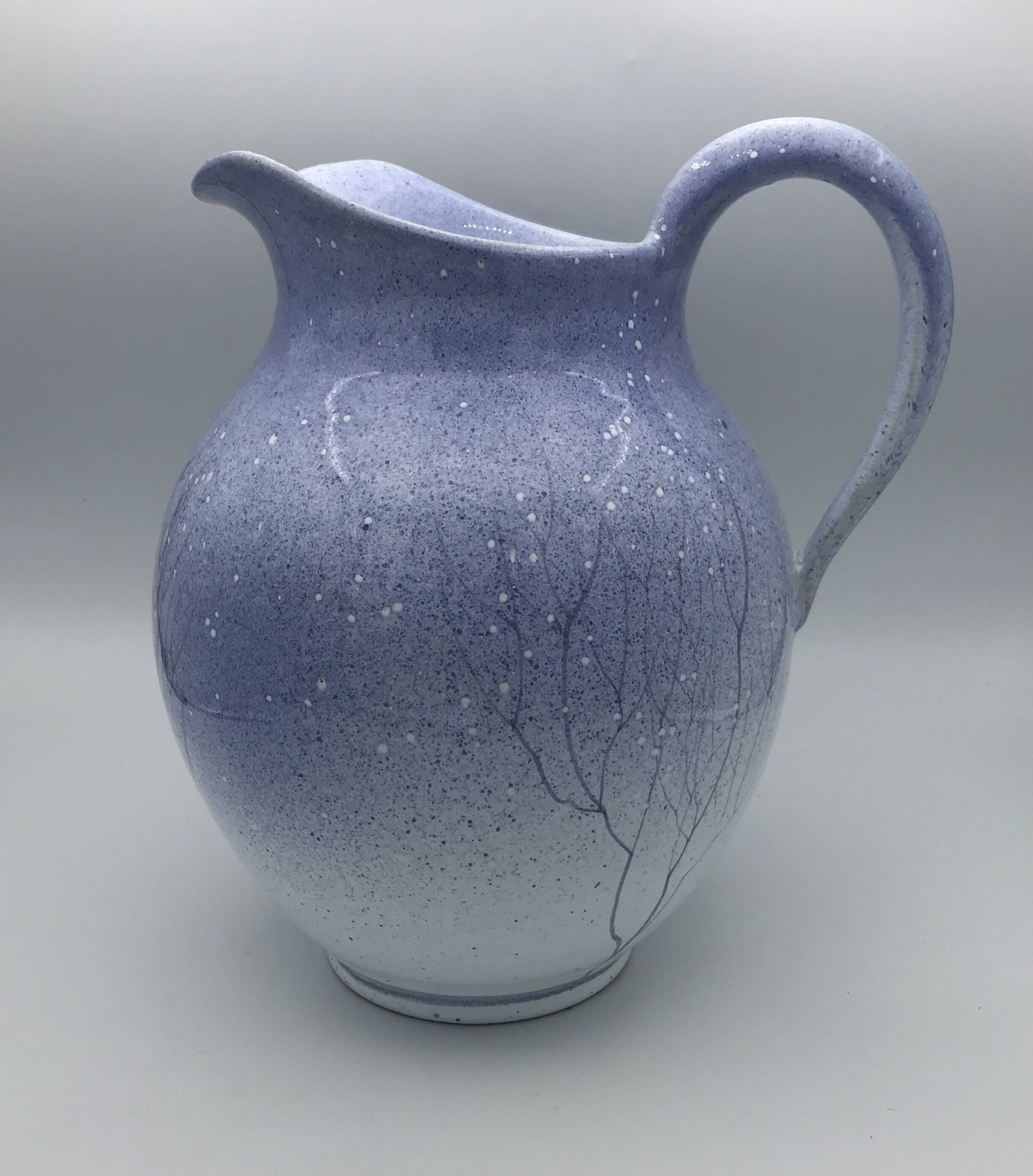 Blue glazed terracotta pitcher with hand-painted decoration, signed