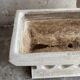 Pair of sculptural cast concrete planters in Off-White, mid-century brutalist style, long and rectangular.