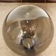 Adjustable metal floor lamp with its vintage smoked ball model from Roger Pradier 1970