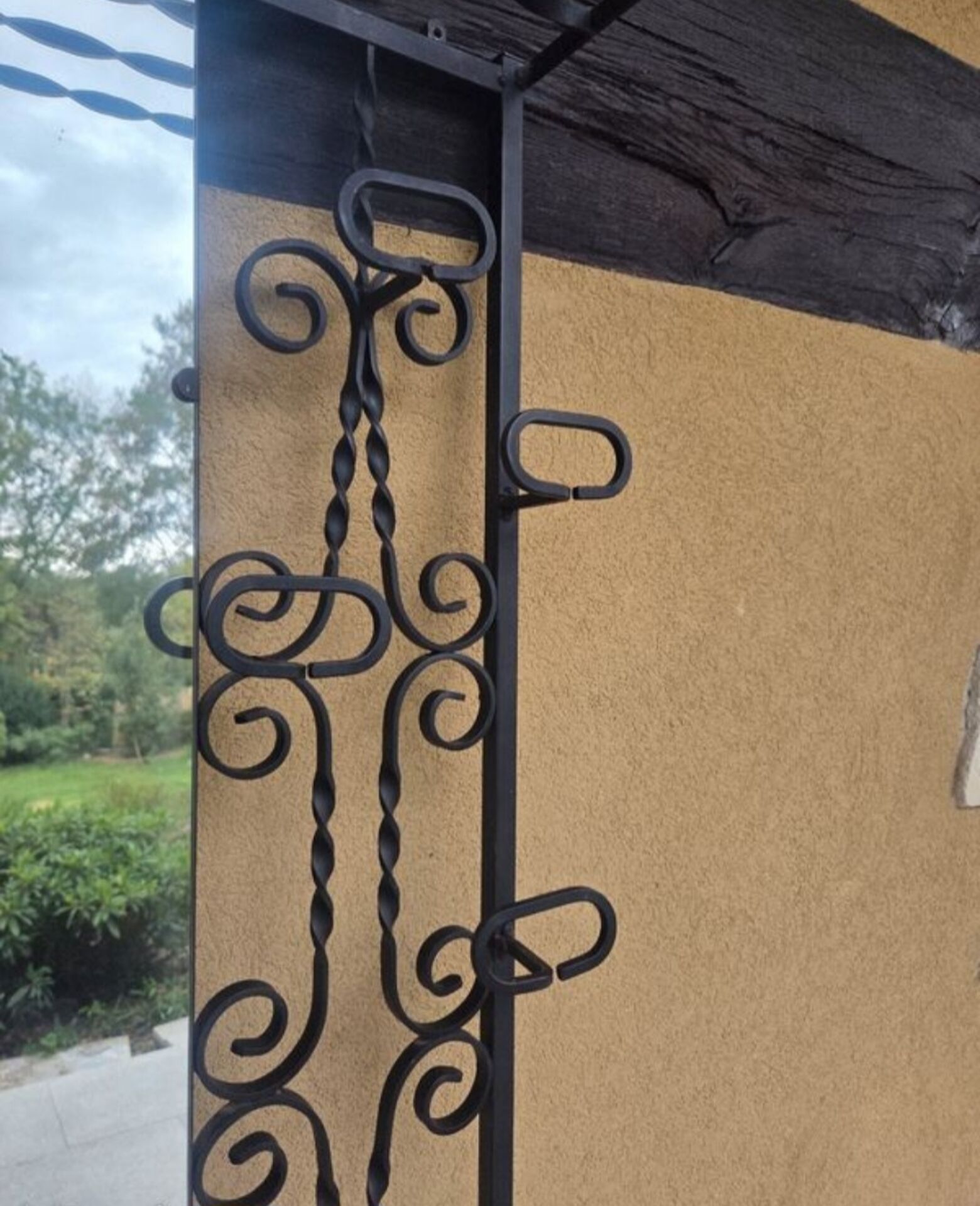 Large vintage wall coat rack in wrought iron with mirror and shelf.