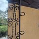 Large vintage wall coat rack in wrought iron with mirror and shelf.