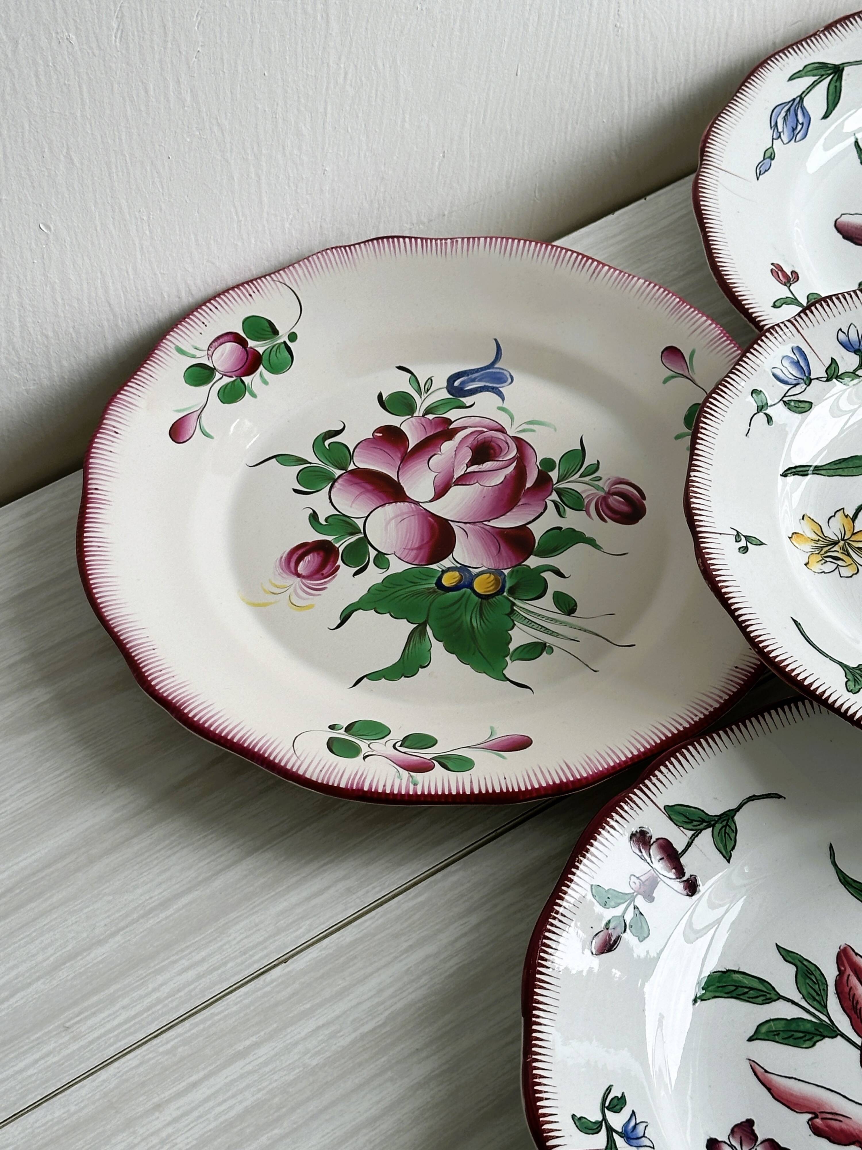 5 plates with colorful Sarreguemines floral designs.