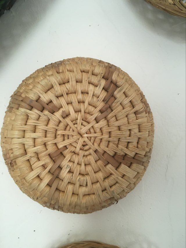 Wall composition of 9 wicker baskets and trays.