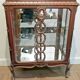A Louis XV style display cabinet with three beechwood shelves and a white marble top.
