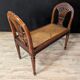 Louis XVI bench in walnut with cane seating.