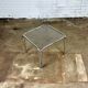 Table basse vintage en métal chromé et verre fumé