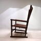 Fauteuil Manou en rotin et assise en cuir, 1960