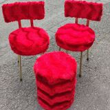 Red furry chairs and pouffe