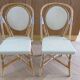 Pair of Parisian bistro chairs from Maison Louis Drucker in light Manila rattan.