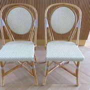 Pair of Parisian bistro chairs from Maison Louis Drucker in light Manila rattan.