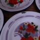 7 printed floral enamel plates "bon voyage" Made in China