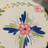 Set of 3 porcelain dishes with floral decorations, with wicker supports.