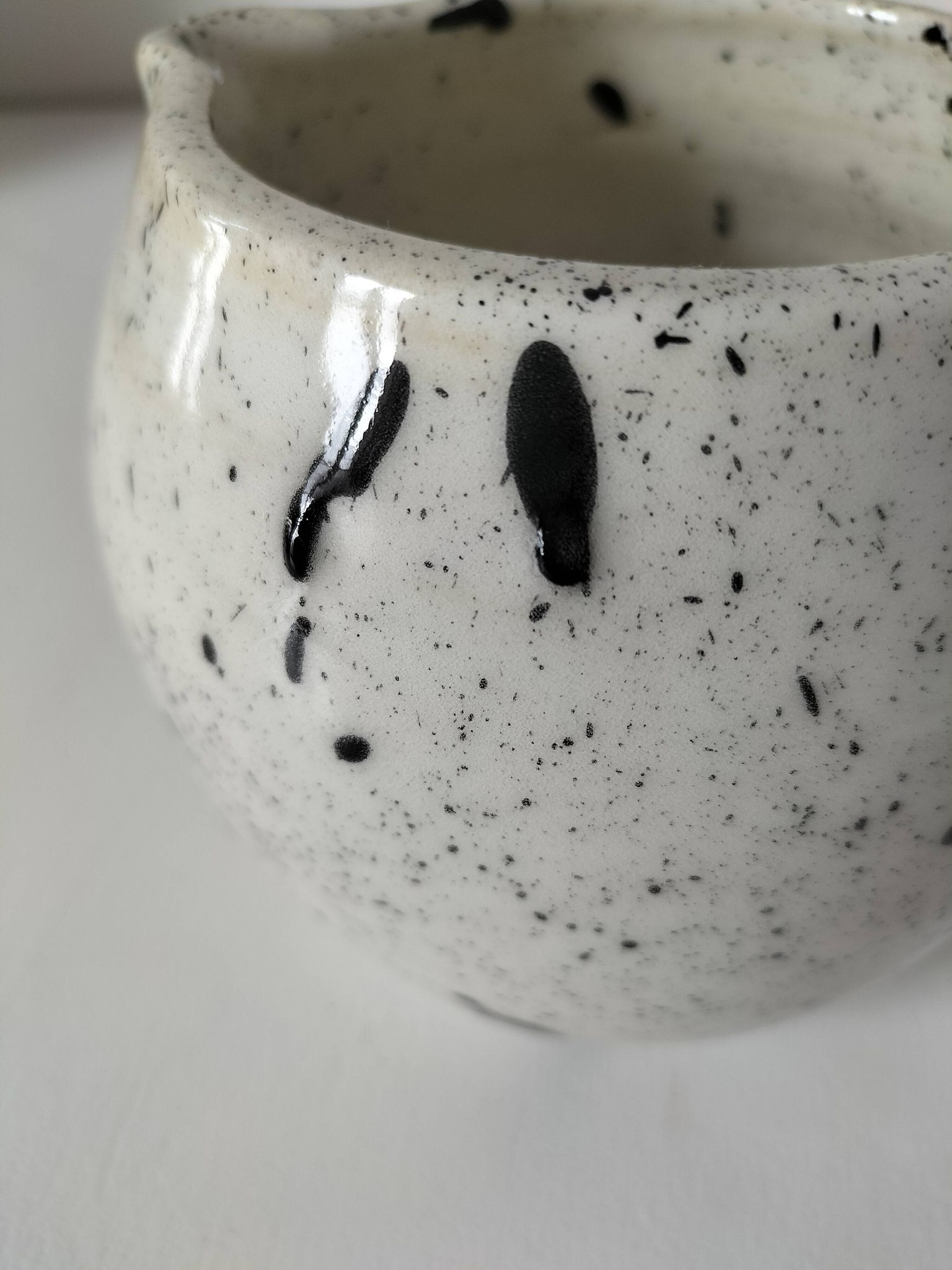 Small speckled ceramic jug in a vintage workshop style.