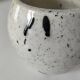 Small speckled ceramic jug in a vintage workshop style.