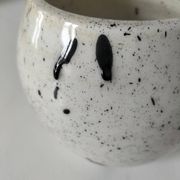 Small speckled ceramic jug in a vintage workshop style.