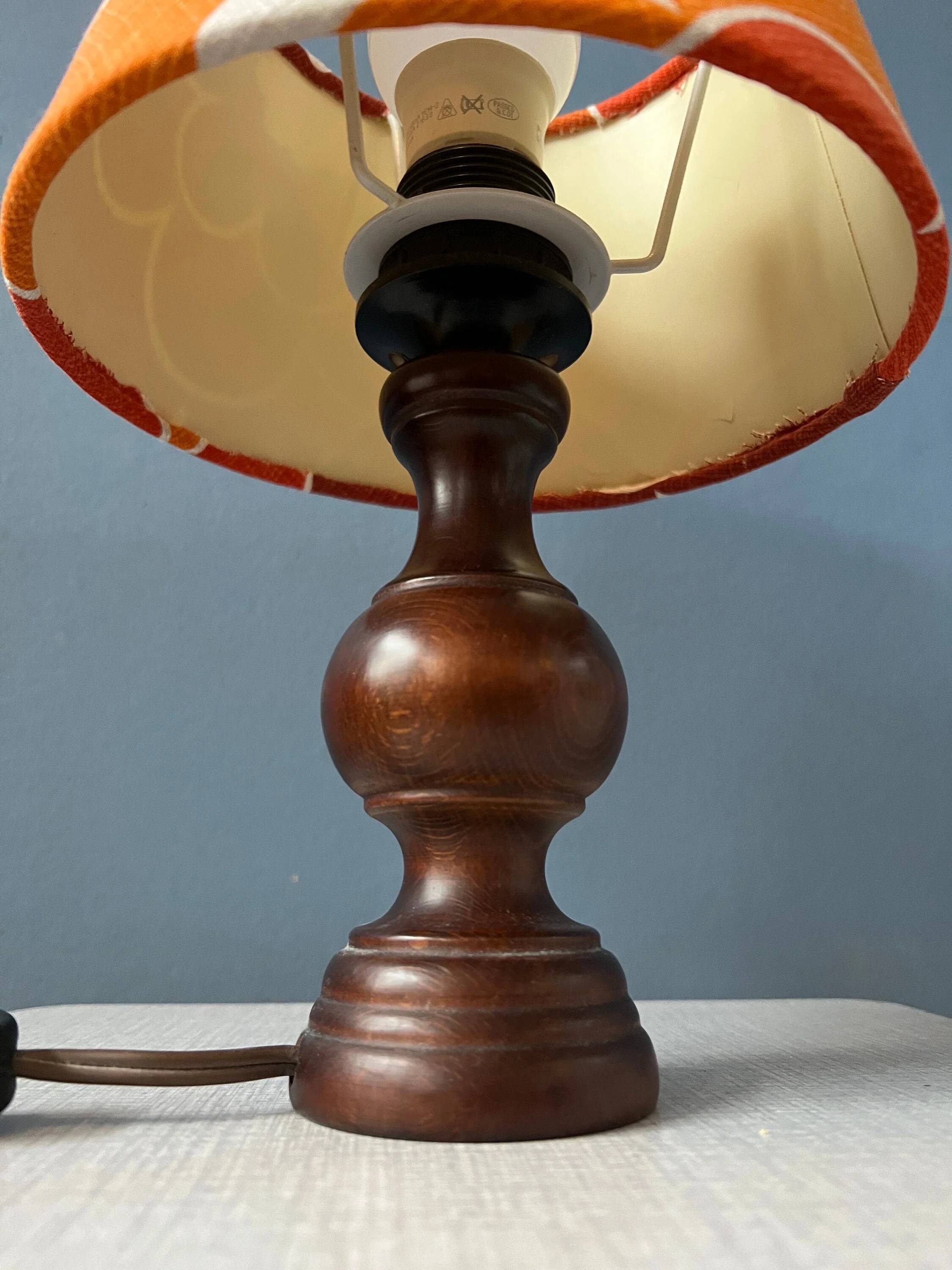 Vintage Space Age table lamp with orange fabric shade.