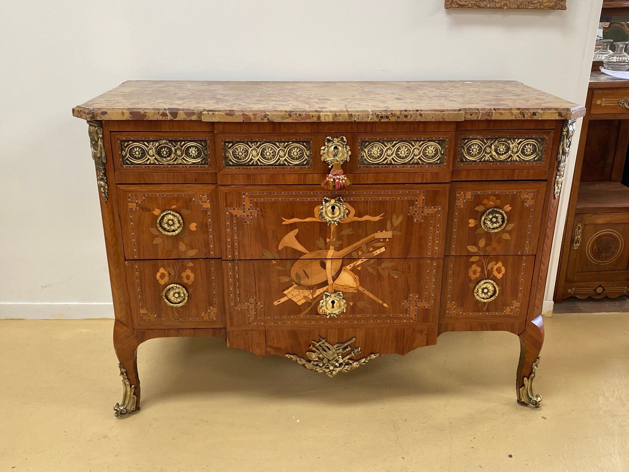 Transition chest of drawers with floral marquetry and music trophy
