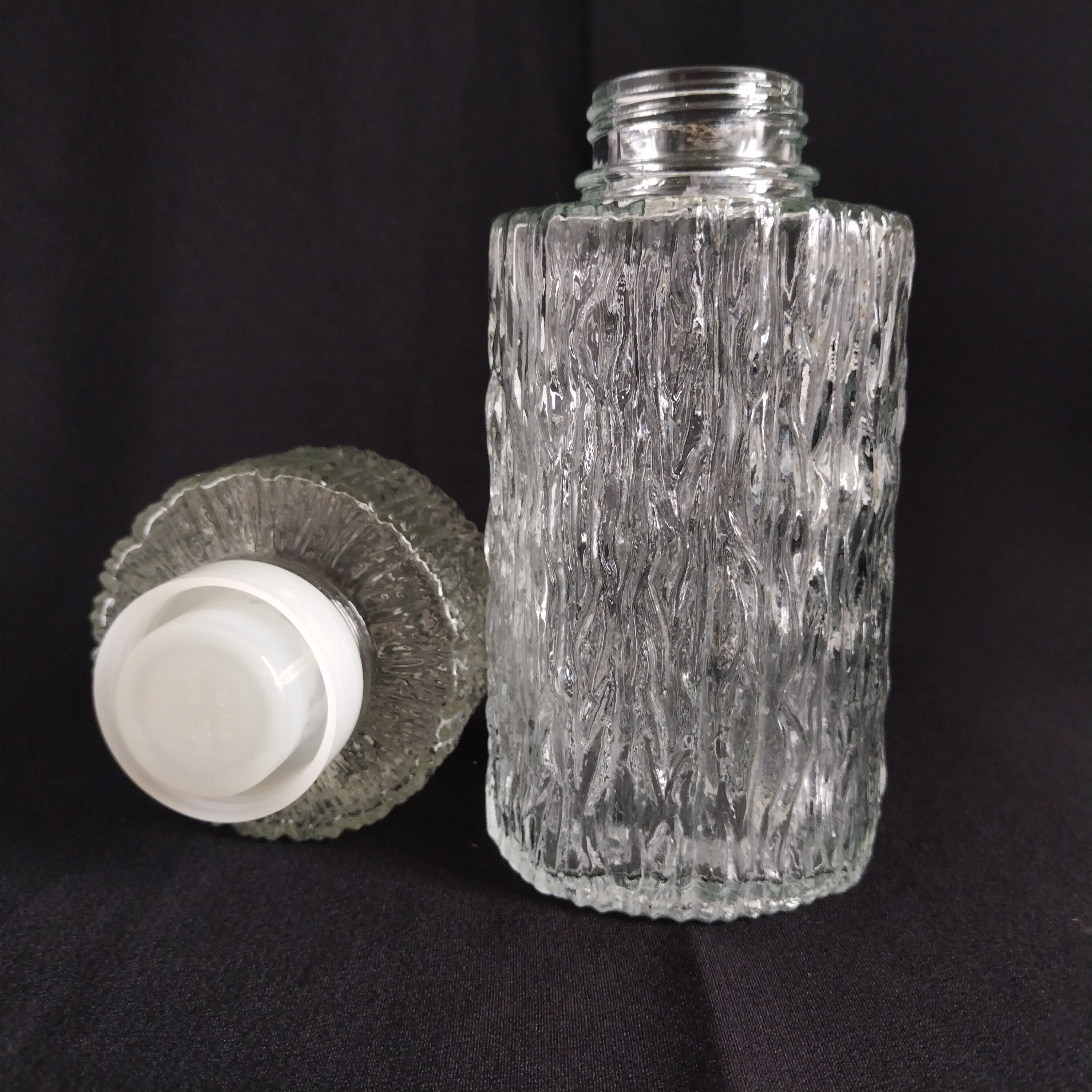 Transparent vintage carafe in pressed glass and its hermetic cap 70's