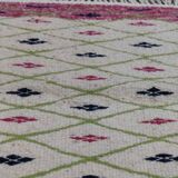 Handmade geometric patterned rug in natural wool