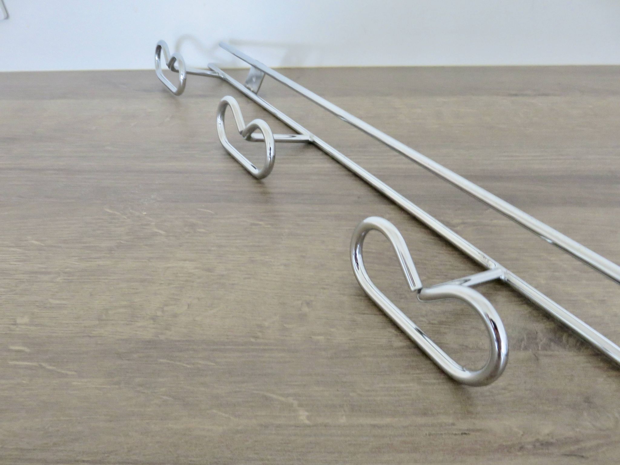 Large vintage wall-mounted coat rack in chrome metal